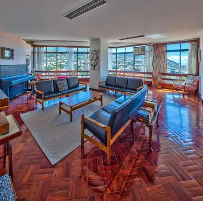 a large living room with couches and tables and windows at Hotel Monte Carlo in Funchal
