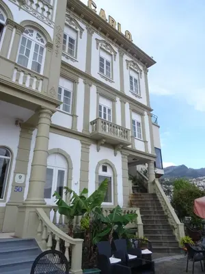 a large white building with stairs in front of it at Hotel Monte Carlo in Funchal
