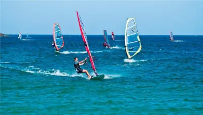 a group of people windsurfing in the ocean at Mareta View - Boutique Bed & Breakfast in Sagres