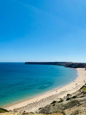 a beach with a group of people in the water at Mareta View - Boutique Bed & Breakfast in Sagres