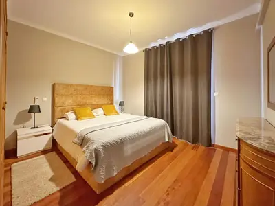 a bedroom with a bed and a large window at Arco da Calheta Villa in Arco da Calheta