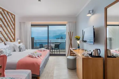 a hotel room with a bed and a view of the ocean at Aqua Natura Bay in Porto Moniz