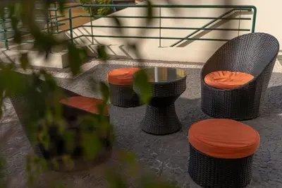 a group of chairs and a table and stool at Charming Villa in Funchal in Funchal