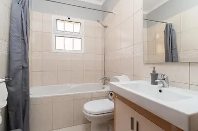 a bathroom with a sink and a toilet and a tub at Charming Villa in Funchal in Funchal