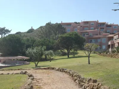 a park with trees and buildings in the background at Belver Porto Dona Maria Resort in Luz