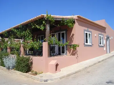 a small pink house with vines at Belver Porto Dona Maria Resort in Luz