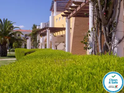 a house with a green lawn in front of it at Luz Bay Hotel in Luz