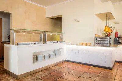 a kitchen with a counter with plates on it at Clube Porto Mos - Sunplace Hotels & Beach Resort in Lagos