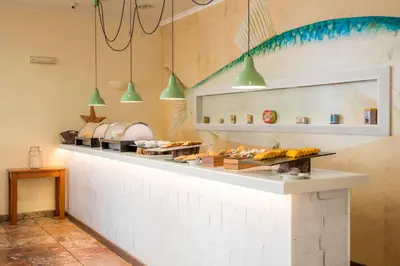 a kitchen with a counter with food on it at Clube Porto Mos - Sunplace Hotels & Beach Resort in Lagos
