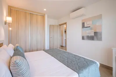 a bedroom with a bed and a painting on the wall at Clube Porto Mos - Sunplace Hotels & Beach Resort in Lagos
