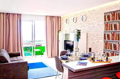 a kitchen with white cabinets and a sink at Modern apartment in Funchal with sea view 70 m² in Funchal