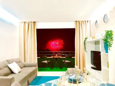 a kitchen with two red bar stools in a kitchen at Modern apartment in Funchal with sea view 70 m² in Funchal