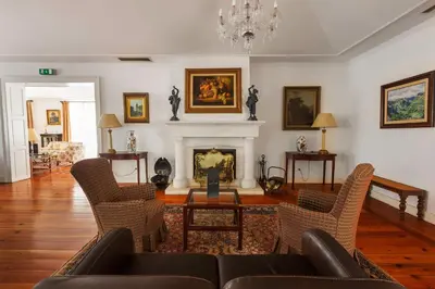 a living room with a couch and a fireplace at Quinta do Monte in Funchal
