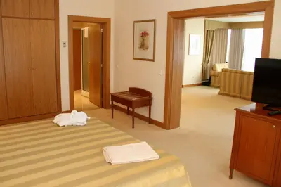 a hotel room with a bed and a television at Quinta do Monte in Funchal