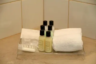 two bottles ofodorizers sitting next to a towel at Quinta do Monte in Funchal