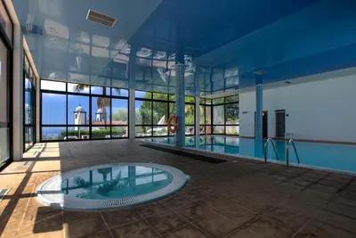 a large building with a pool in the middle at Quinta do Monte in Funchal