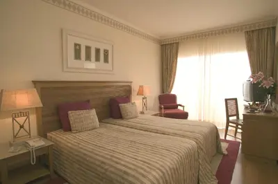 a hotel room with a bed and a television at Quinta do Estreito in Estreito de Câmara de Lobos