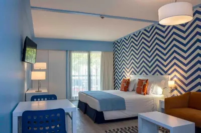 a hotel room with a bed and a couch at Terrace Mar Suite Hotel in Funchal