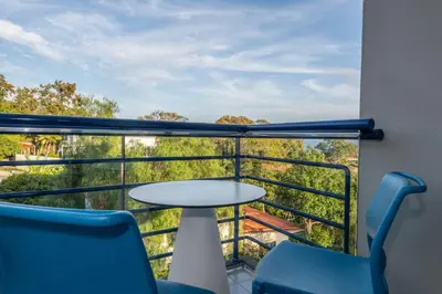 a balcony with a table and chairs and a view at Terrace Mar Suite Hotel in Funchal