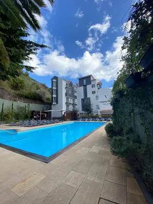 a large swimming pool in front of a building at Santa Cruz Village Hotel in Santa Cruz