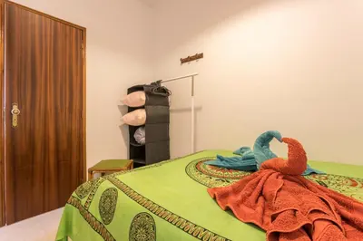 a bedroom with a bed with a towel on it at Geo House in Vila do Bispo