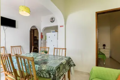 a kitchen and dining room with a table and chairs at Geo House in Vila do Bispo