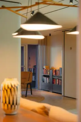 a room with a library with a table and a chair at Duas Torres Hotel in Funchal
