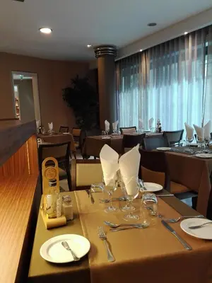 a dining room with a table with wine glasses on it at Hotel Windsor in Funchal