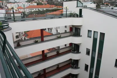 an aerial view of a white building with balconies at Hotel Windsor in Funchal