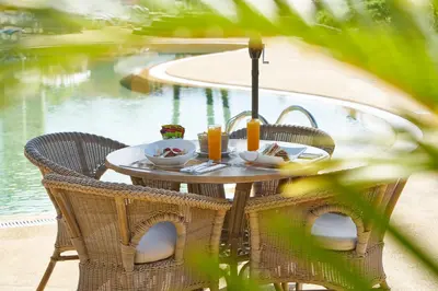 a table with a plate of food and drinks on it at PortoBay Santa Maria - Adults Only in Funchal