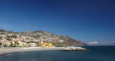 a view of a beach with a town on a hill at PortoBay Santa Maria - Adults Only in Funchal