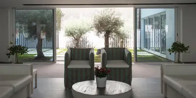 a waiting room with two chairs and a table at Hotel Alto Lido in Funchal