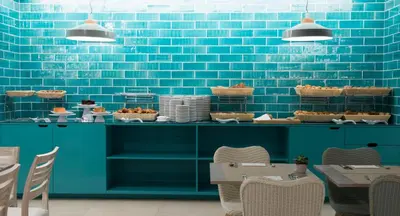 a blue tiled wall in a restaurant with tables and chairs at Hotel Alto Lido in Funchal