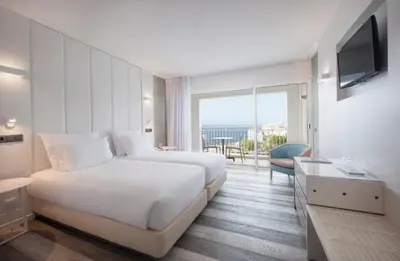 a hotel room with a bed and a large window at Hotel Alto Lido in Funchal