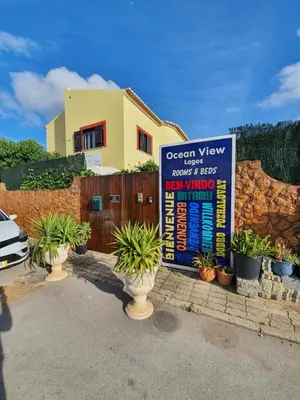 a sign in front of a house with potted plants at Ocean View Lagos in Lagos