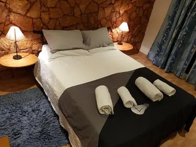 a bedroom with a large bed with towels on it at Ocean View Lagos in Lagos