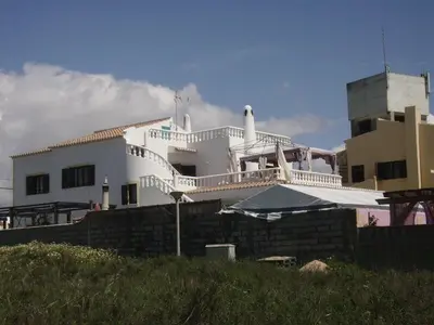 a white house with a balcony on top of it at Ocean View Lagos in Lagos