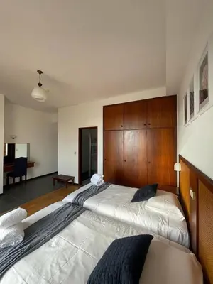 a bedroom with a large bed with a wooden headboard at Valhalla Panorama in Funchal