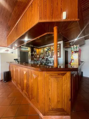 a bar in a restaurant with wooden cabinets at Valhalla Panorama in Funchal