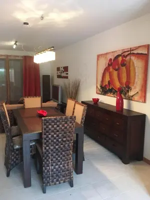a dining room with a table and a painting on the wall at casa de praia Nunes Village in Porto Santo