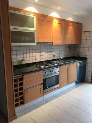 a kitchen with wooden cabinets and a stove top oven at casa de praia Nunes Village in Porto Santo