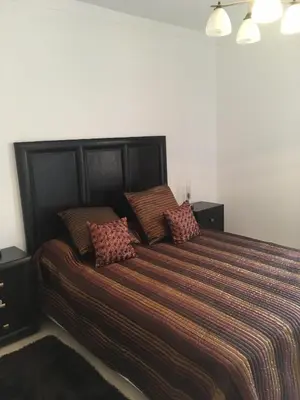 a bedroom with a large bed with pillows on it at casa de praia Nunes Village in Porto Santo