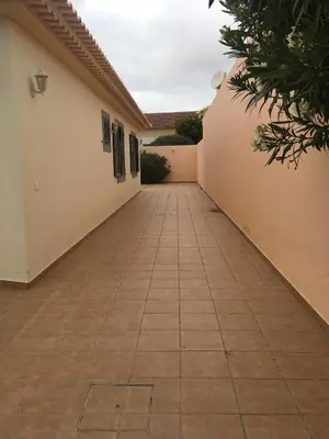 a walkway leading into a house with a building at casa de praia Nunes Village in Porto Santo