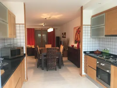 a kitchen with a table and a dining room at casa de praia Nunes Village in Porto Santo