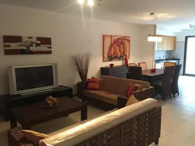 a living room with a couch and a tv at casa de praia Nunes Village in Porto Santo