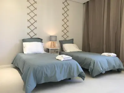 two beds sitting next to each other in a room at Apartamento Reis Magos in Caniço
