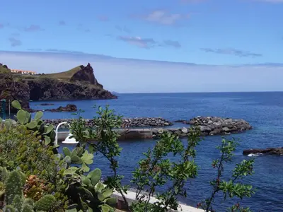 a view of the ocean with boats in the water at Apartamento Reis Magos in Caniço