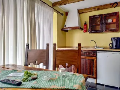 a kitchen with a table and a sink and a counter at Calhau Grande in Arco da Calheta
