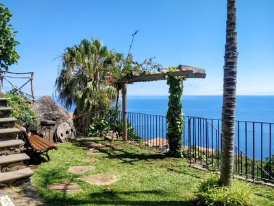 a gate with a view of the ocean at Calhau Grande in Arco da Calheta