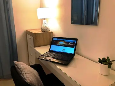 a laptop computer sitting on top of a desk at Villa SCIROCCO Madeira - Ocean View in Machico